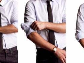 تصویری از یک مرد جوان که پیراهن و کراوات و شلوار ساده و ساعت مچی بند چرمی بر دست دارد. او درحال بالا زدن آستین پیراهن سفید خود در سه مرحله است.